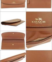 茶色い革製の長財布 COACHの画像